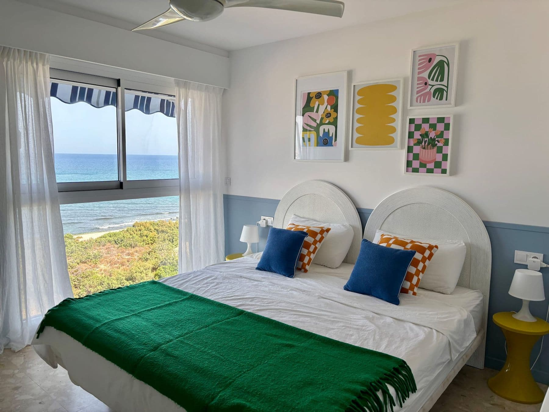 Main bedroom with king-size bed and a window on the sea